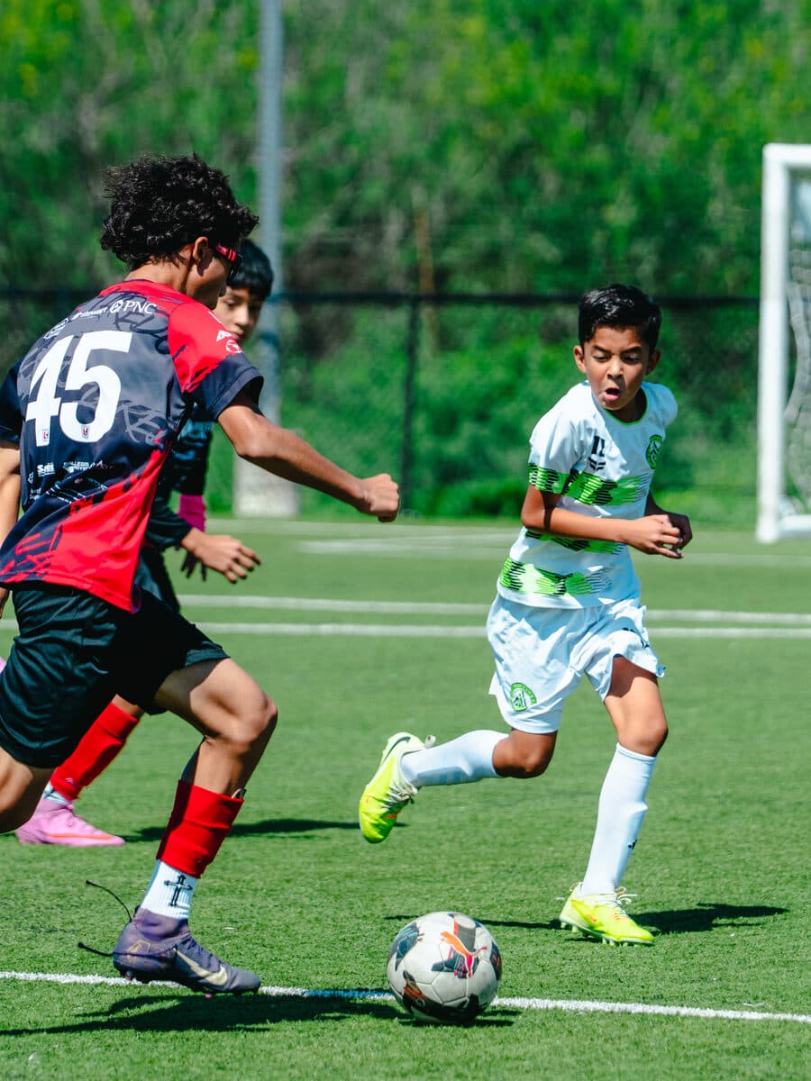 Apex United FC players competing one on one for the ball in San Antonio