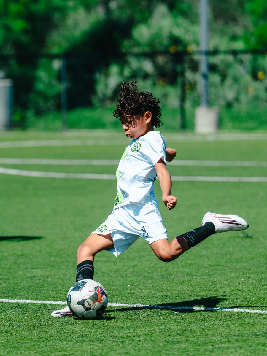 Apex United FC youth player shooting on goal in San Antonio